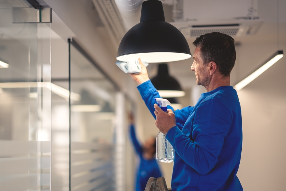 professional,hygiene,maintenance.,a,cleaner,cleans,the,chandelier,in,the